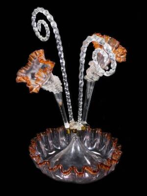 An Edwardian amber and clear glass epergne, with two barley sugar twist pieces and two trumpets, on a shaped floral base, with amber coloured outline, 39cm H.