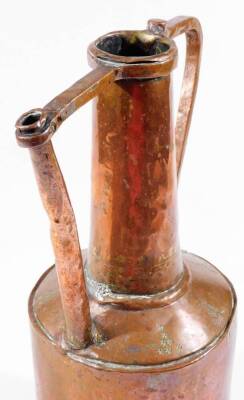 A late 19thC Middle Eastern copper vessel, with cylindrical stem flanked by shaped handles, on a bell shaped body with stapled metal base, 40cm H. - 2