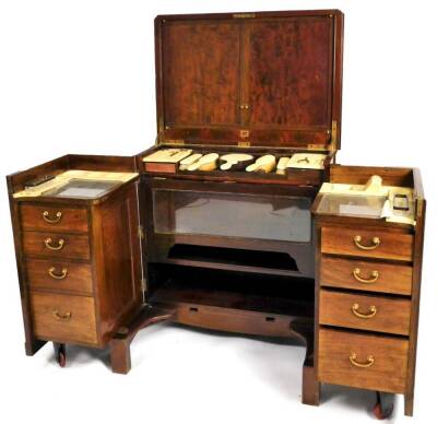 A 19thC mahogany fitted travelling dressing chest, of rectangular form, the hinged lid with internal mirrors and metal clasp opening, above a full fitted interior containing various darning implements, brushes, etc. the front hinging to reveal an arrangem