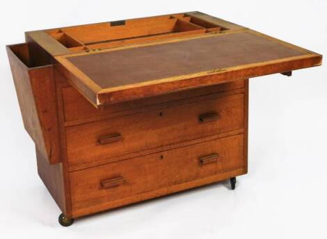 An early 20thC oak games chest, of rectangular form, with side opening, quarter veneered flip top and three drawers, with a fitted interior and shaped loafers, 72cm H, 87cm W, 43cm D.