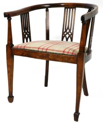 An Edwardian mahogany and boxwood strung tub chair, with partially pierced back, overstuffed seat in checked red and cream material, on square tapering front legs terminating in spade feet, 80cm H.