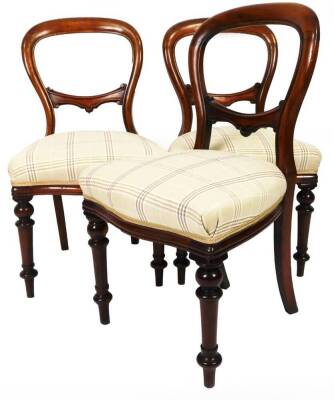 A set of three Victorian mahogany balloon back chairs, each with horizontal scroll back splats, overstuffed seats in check material, on turned front and sabre back legs, 93cm H. (3)