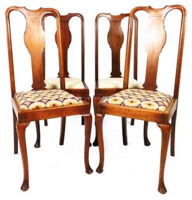 A set of four early 20thC walnut Queen Anne style dining chairs, each with carved hour back splats, drop in seats, on turned cabriole legs terminating in pad feet, 110cm H. (4, AF)