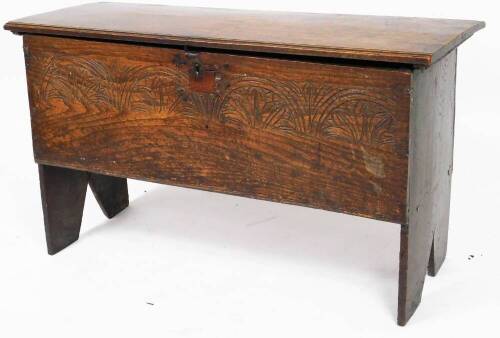 A principally 17thC boarded chest, of rectangular form, with carved front, on shaped stiles, with candle box to the interior, 62cm H, 112cm W, 42cm D.