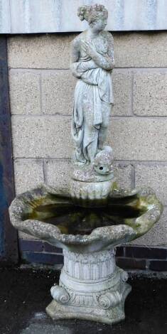 A late 20thC concrete water feature, set with Venus above a shell, on an inverted scroll base, 137cm H.