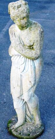 A late 20thC concrete garden statue, of a classical figure of a lady semi-clad in flowing robes, on a circular foot, 118cm H.