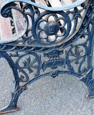 An early 20thC cast iron and slatted wooden garden chair, with shaped floral and mask sides, on shaped feet, 80cm H. - 2