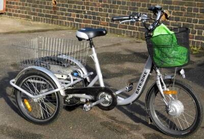 A Batirbike battery tricycle, in silver and black trim, with bell, gears and basket, 110cm H. Instruction booklet in office.