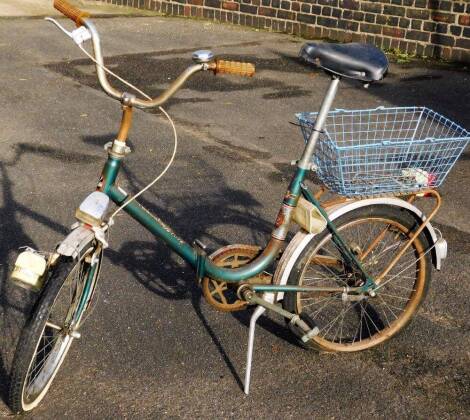 A ladies Toscana Deluxe vintage bicycle, with green frame, black saddle and blue basket, 102cm H.