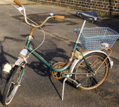 A ladies Toscana Deluxe vintage bicycle, with green frame, black saddle and blue basket, 102cm H.