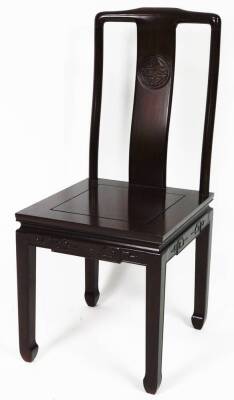 A 20thC Chinese hardwood dining chair, with shaped vertical splat set with a carved orb, on square seat, above square legs terminating in turned scroll feet, 102cm H.