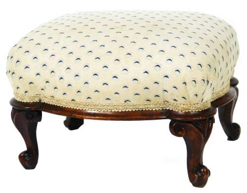 A 19thC mahogany footstool, of rectangular inverted form, on compressed legs terminating in scroll feet, overstuffed in a repeat geometric pattern material in blue and cream, 32cm H, 35cm W, 29cm D.