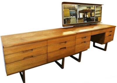 A vintage teak bedroom pair, comprising mirror back dressing table and dressing chest, of six short drawers on D end shaped legs, 71cm H, 121cm W, 46cm D.