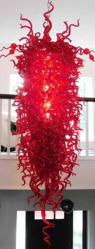 A large and impressive Murano centrepiece chandelier or shade, set with various red glass shaped sections, on a central tapering cone, with plain ring top and chain light fitting, of very large proportion and of graduated form, approx. 3m H x 110cm Dia. a