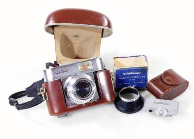 A Voigtlander camera, with chrome mounts, in brown leather case, 12cm H, with lens and other accessories. (a quantity)