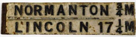 A cast iron sign Normanton 3/4 M and Lincoln 17 1/4 M, in black and white colour way, 79cm W.