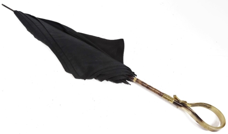 An early 20thC umbrella, with turned handle, gilt coloured collar and wooden bamboo finish stem, canvas top and tip end, 98cm W.