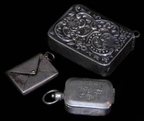 An Edwardian silver stamp case, of envelope form with ring side, Birmingham 1901, 3cm W, an unmarked seal case, repoussé decorated snuff box. (3)