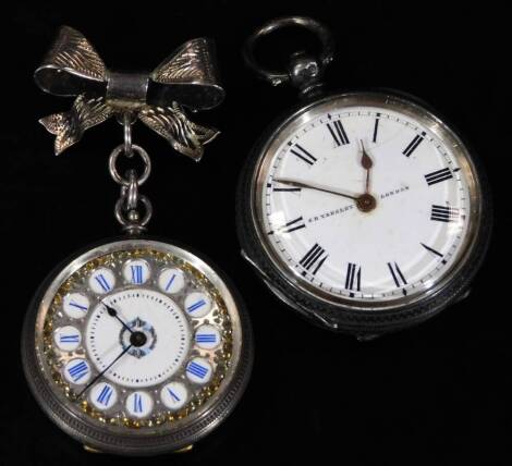 An early 20thC ladies fob watch, marked fine silver, with bow top, fancy 3cm Dia. Roman numeric dial, with tooled centre and engine turned case, 6cm H, and a further silver open faced pocket watch. (2)