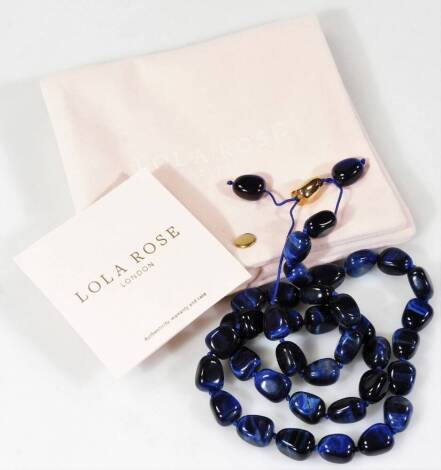 A Lola Rose necklace set with polished blue stones, with gilt coloured clasp, 68cm L. (with outer pouch and paperwork)