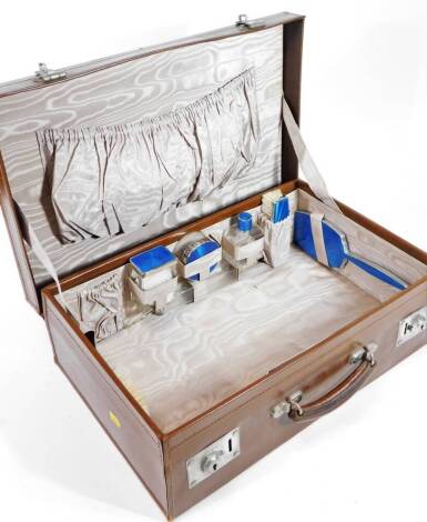 An early 20thC brown leather fitted travel case, of rectangular form, set with bottles, dressing table set, etc. with chrome mounts, marked Improved Klipit Model, 15cm H, 51cm W, 33cm D.