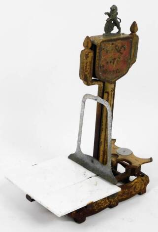 A Lion quick action cast iron floor scale, surmounted by lion, with shaped pan and open section articulating at the centre, on a fixed base, 67cm H.