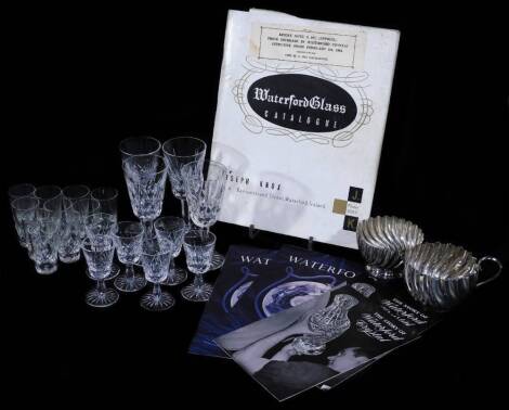 Six Waterford Crystal Lismore shot glasses, various other Waterford Crystal drinking glasses, sherry glasses, a 1963 catalogue and other pamphlets relating to Waterford and a Mappin and Webb cream jug and sugar bowl. (a quantity)