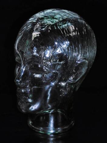 A 20thC press moulded glass display head, 27cm H.