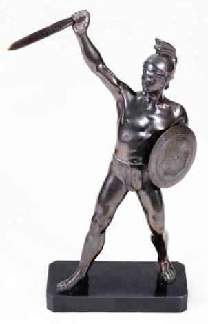 A classical bronzed figure, of a warrior holding dagger and shield, on canted base, unsigned, 29cm H.