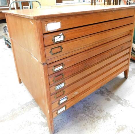 A teak plan chest, of rectangular form, set with various long drawers, on shaped legs, in two sections, 93cm H, 122cm W, 92cm D.