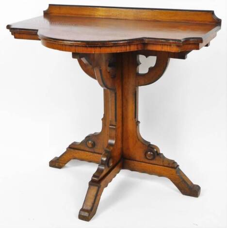 An ecclesiastical side table, with shaped top, with galleried back, on shaped stem and scroll feet, 77cm H, 81cm W, 50cm D.
