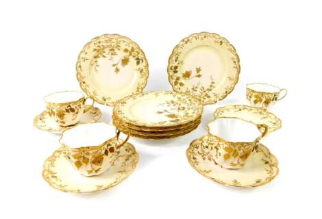 A Limoges late 19thC porcelain part tea service, of spiral fluted form, gilt decorated with blossom and trailing leaves, comprising four tea cups, saucers and six tea plates, marked for JC, Limoges.