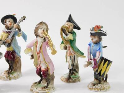 A set of six Volkstedt 20thC porcelain monkey band figures, comprising conductor, French horn, mandolin and trumpet players, a cellist and a drummer. - 3