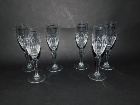 A set of six Dartington cut glass champagne flutes, with semi fluted and leaf engraved bowls, raised on hexagonal baluster stems, etched mark, 21cm H.