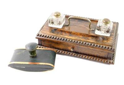 A Victorian oak desk stand, with two glass inkwells, pen recesses over a single frieze drawer, raised on bun feet, plaque presentation engraved, 29cm W, 19cm D, together with a green leather and copper bound desk blotter. (2)