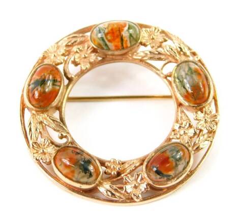 A 9ct gold rose gold and moss agate brooch, of circular form, with five oval cabachons, interspersed with embossed flowers, 13.4g.