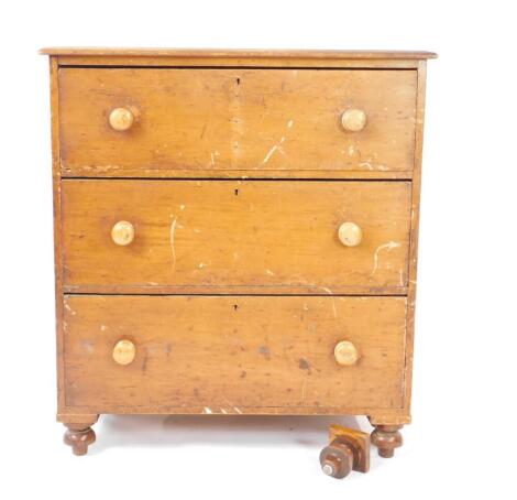 A Victorian pine chest of drawers, with three long drawers, raised on bun feet, 105.5cm H, 96cm W, 46.5cm D.