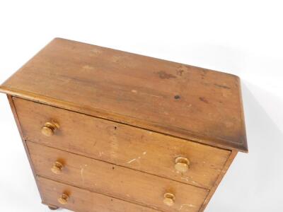 A Victorian pine chest of drawers, with three long drawers, raised on bun feet, 105.5cm H, 96cm W, 46.5cm D. - 2