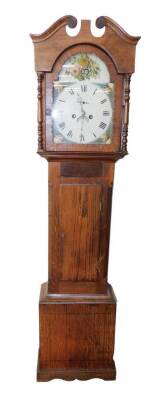 A George III oak longcase clock, the break arch enamel dial painted with floral spandrels, circular dial bearing Roman numerals, subsidiary seconds dial and date aperture, two train eight day movement with bell strike, the break arch hood with turned colu