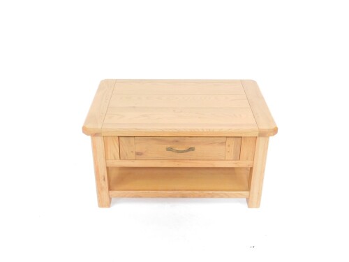 A light oak occasional table, the canted rectangular plank top, over a single frieze drawer, raised on square legs, united by an under tier, 49.5cm H, 93cm W, 62.5cm D.