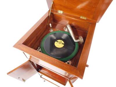 An Edwardian mahogany and satin wood cross banded cabinet gramophone, the levered top opening to reveal the movement, above two doors, enclosing the sound box, above a cupboard, raised on tapering square legs, capped on castors, with winder, 114cm H, 47c - 4