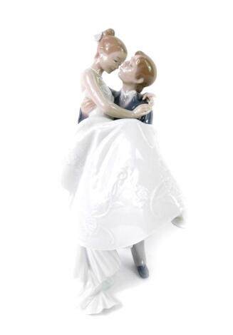 A Lladro porcelain figure modelled as The Happiest Day, printed mark, 27cm H, boxed.