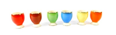 A Romanian 20thC harlequin set of six pottery egg cups, boxed.