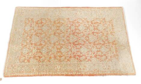 A Pakistan Amritsar design rug, decorated with floral motifs against a red ground, 188cm x 123cm.