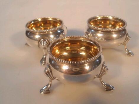 A set of 3 mid Victorian silver circular salts with silver gilt interiors