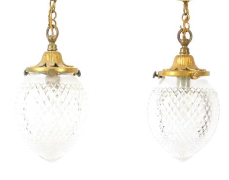 A pair of Edwardian style brass and cut glass ceiling lights, with teardrop shades, and suspension chains, 25cm H, excluding chains.