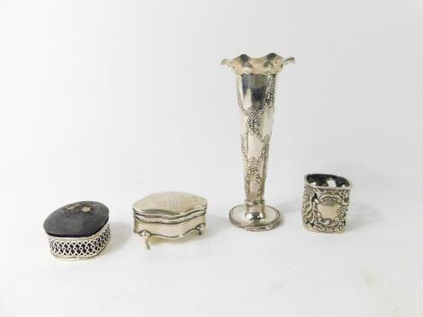 An Edward VII silver spill vase, of trumpet form, embossed with harebell swags, Birmingham 1901, silver scent bottle holder, repousse decorated with cherubs and rococo scrolls, Chester 1898, Edward VII silver jewellery casket, of serpentine form with engr