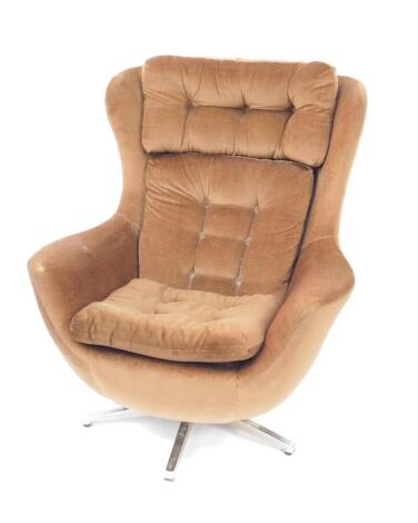 A Parker Knoll 1970s swivel egg chair, upholstered in brown button back draylon, raised on a five prong metal base.