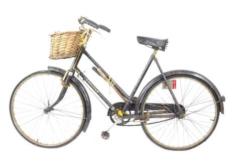 A Hercules Cycle and Motor Company Popular bicycle, painted black, with front mounted wicker basket.