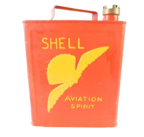 A Shell Aviation Spirit petrol can, painted red and highlighted in yellow.